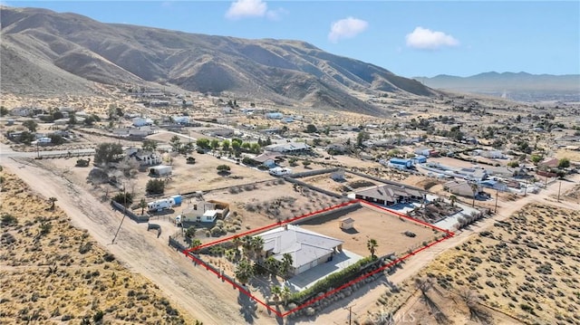 birds eye view of property with a mountain view