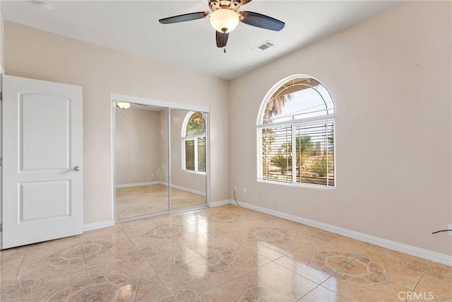 unfurnished bedroom with a closet and ceiling fan