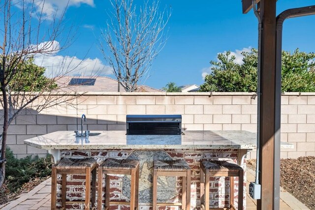 view of patio / terrace featuring exterior bar and area for grilling