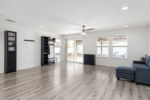 living room featuring ceiling fan and light hardwood / wood-style flooring