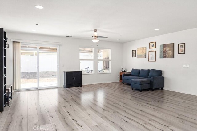 living room featuring ceiling fan and light hardwood / wood-style flooring