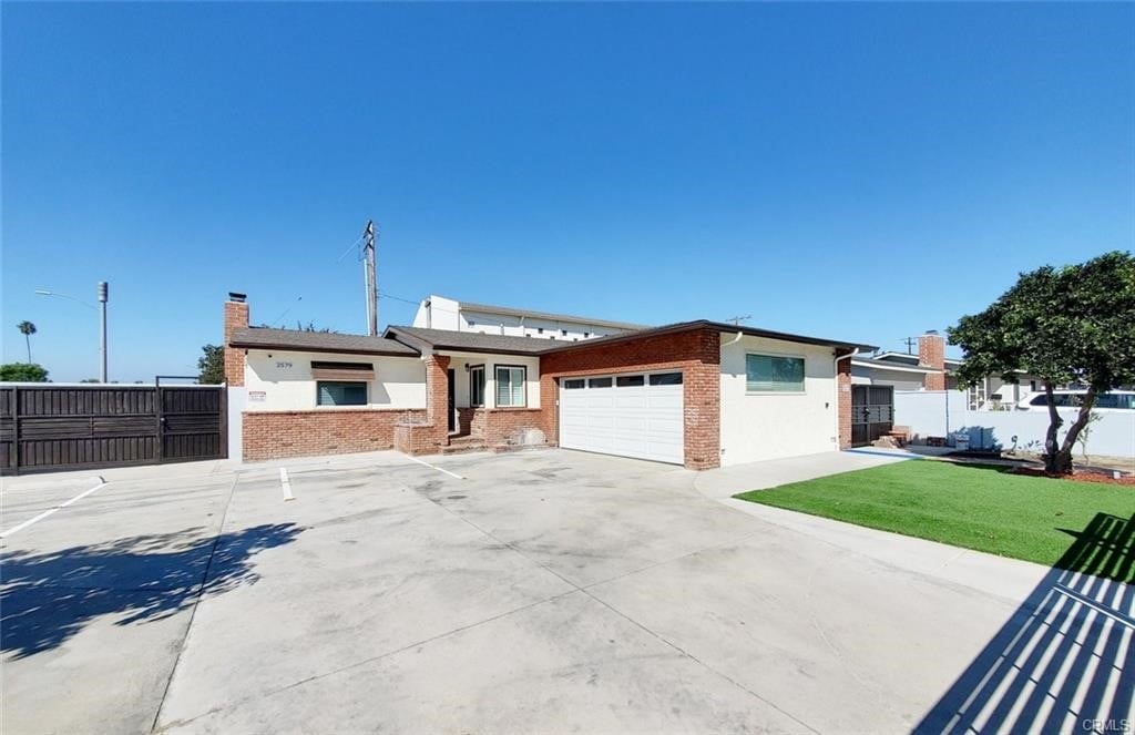 view of front of home with a garage and a front yard