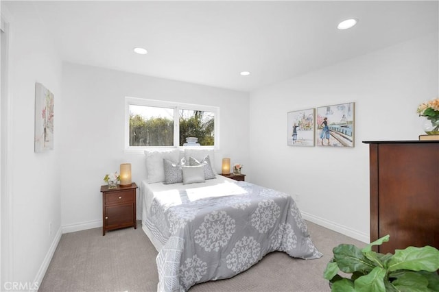 bedroom with baseboards, recessed lighting, and light colored carpet