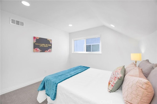 bedroom featuring lofted ceiling and carpet