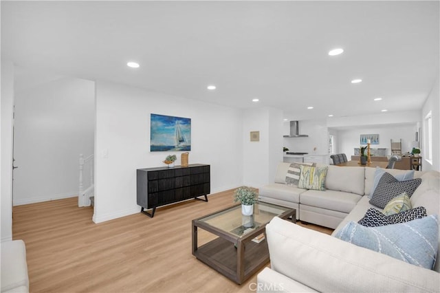 living area featuring baseboards, recessed lighting, and light wood-style floors