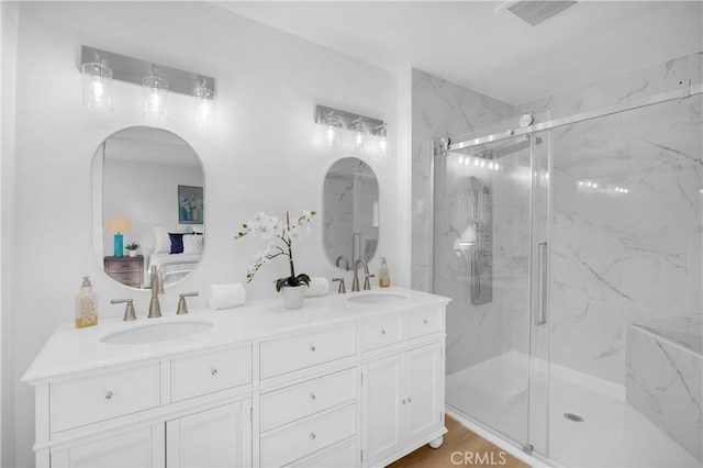 bathroom featuring vanity, hardwood / wood-style flooring, and a shower with shower door