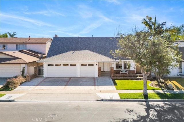 view of front of home with a garage and a front yard