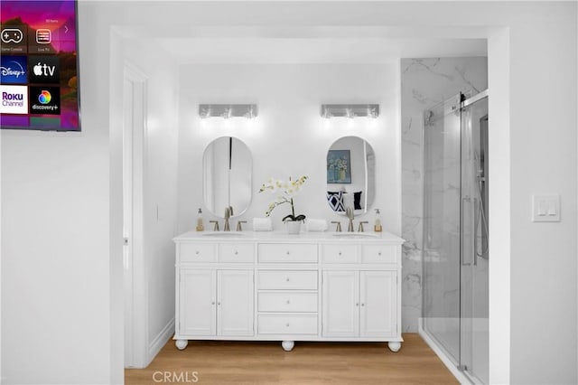 bathroom featuring vanity, hardwood / wood-style floors, and an enclosed shower