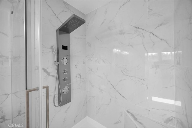 bathroom with a marble finish shower