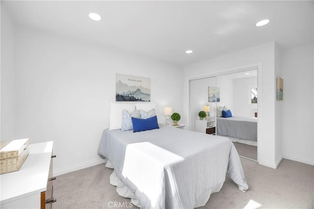 bedroom featuring recessed lighting, light colored carpet, and baseboards