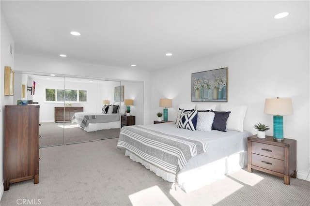 bedroom with light carpet, a closet, visible vents, and recessed lighting