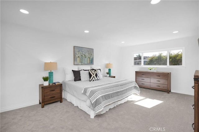 bedroom featuring recessed lighting, light colored carpet, and baseboards