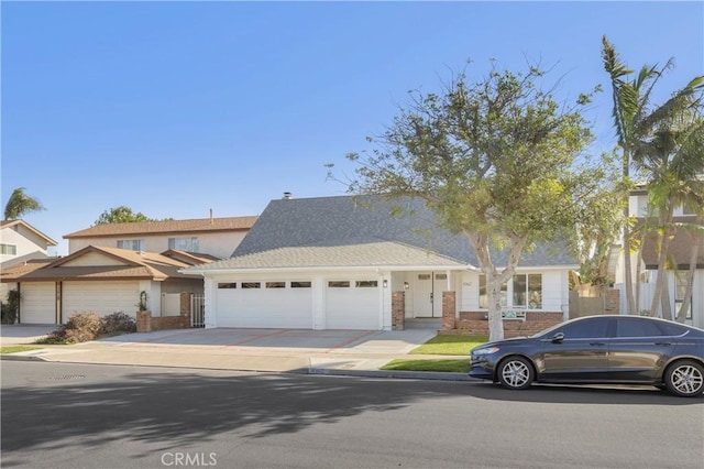 view of front of home with concrete driveway and an attached garage