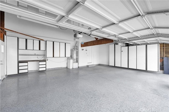 garage featuring water heater and a garage door opener