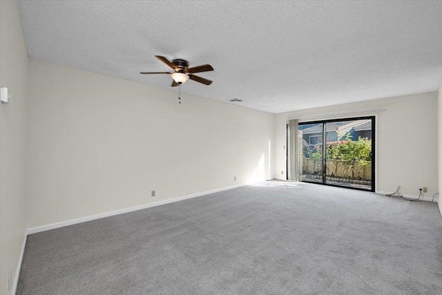 spare room featuring ceiling fan, a textured ceiling, and carpet