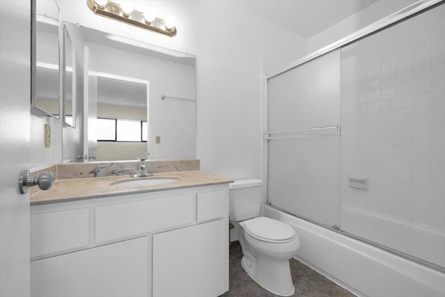 full bathroom featuring vanity, shower / bath combination with glass door, and toilet