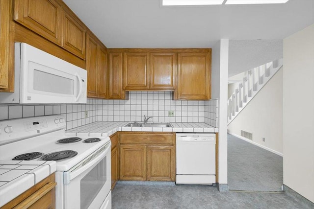 kitchen with white appliances, tile countertops, sink, and backsplash