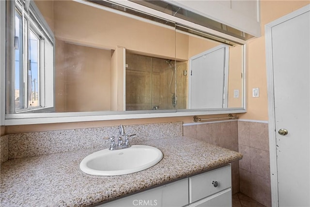 bathroom with vanity and tile walls