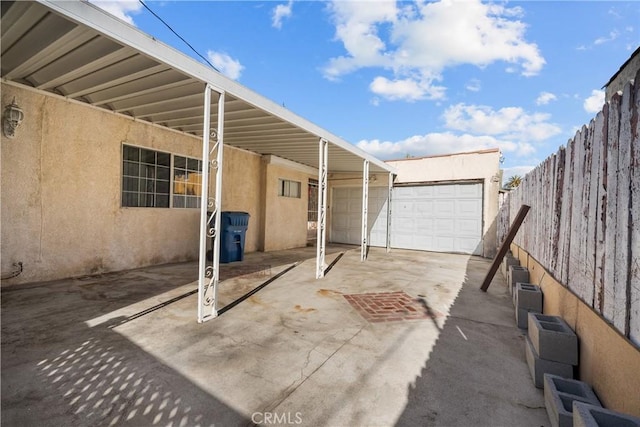 view of patio / terrace with a garage and an outdoor structure