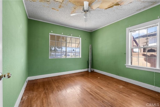 unfurnished room with hardwood / wood-style flooring, ceiling fan, ornamental molding, and a textured ceiling