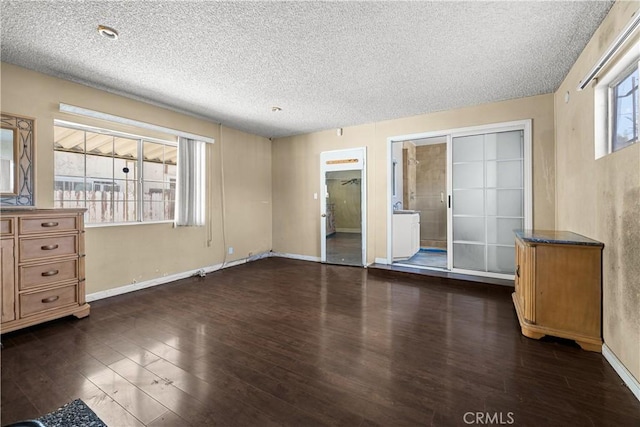 empty room featuring dark hardwood / wood-style floors and a textured ceiling