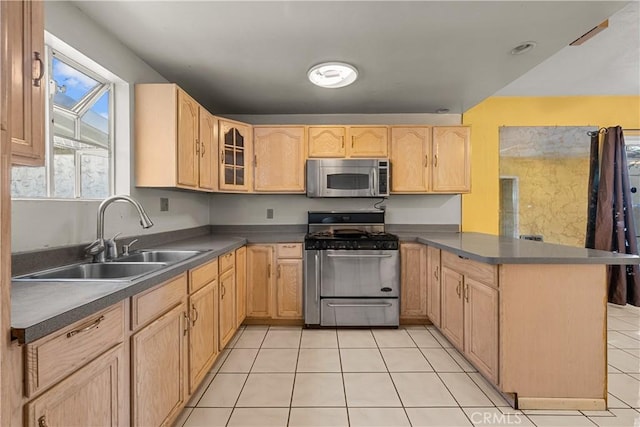 kitchen with sink, appliances with stainless steel finishes, light tile patterned flooring, kitchen peninsula, and light brown cabinets