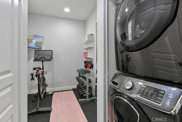 laundry room featuring stacked washer / drying machine