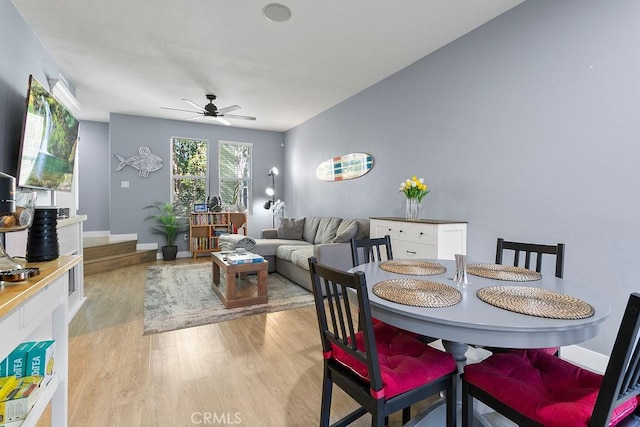 dining space featuring light hardwood / wood-style flooring and ceiling fan