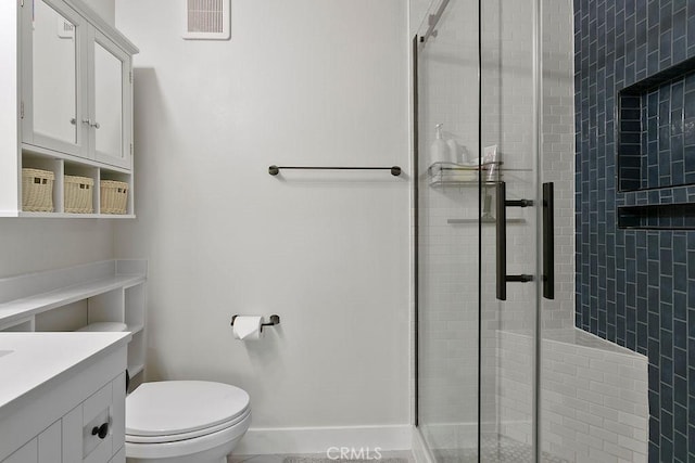 bathroom featuring vanity, toilet, and walk in shower