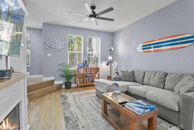 living room featuring ceiling fan and light wood-type flooring