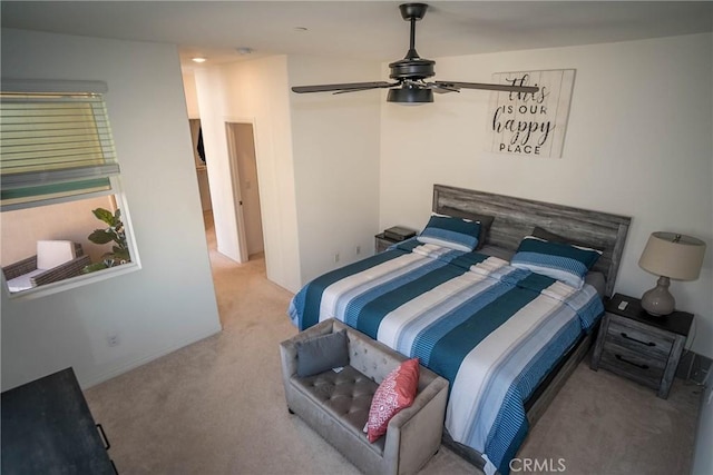 bedroom with ceiling fan and light carpet