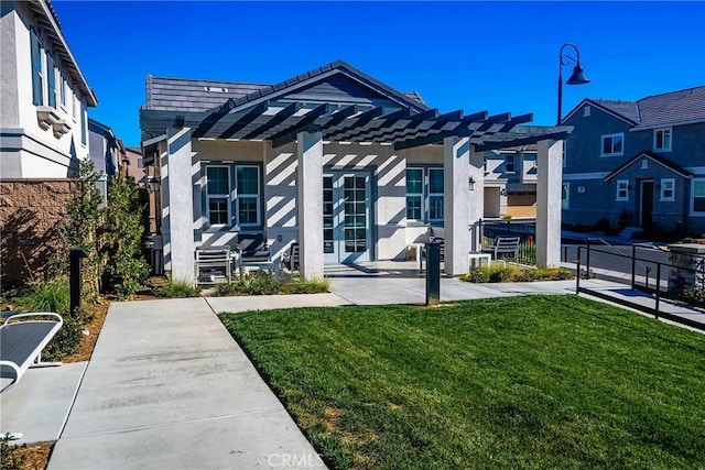 view of front of house featuring a front yard, a patio area, and a pergola