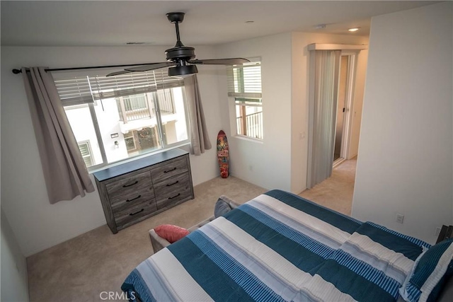 bedroom with ceiling fan and light carpet