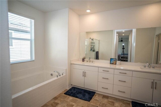 bathroom with vanity, a wealth of natural light, and ceiling fan