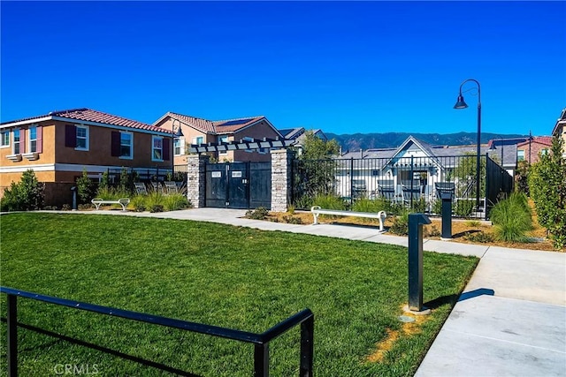 view of home's community featuring a mountain view and a yard