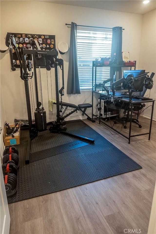 workout area with hardwood / wood-style flooring