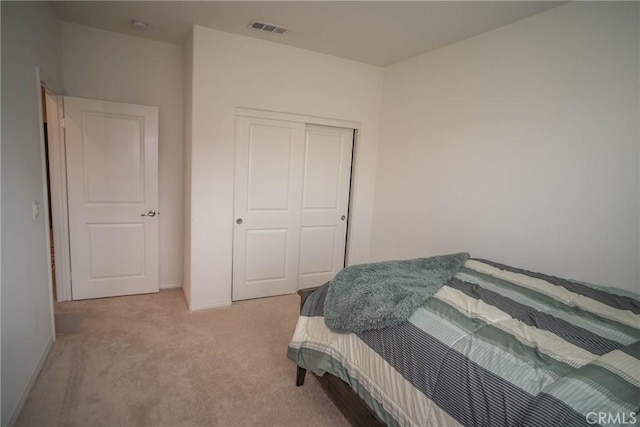 carpeted bedroom with a closet