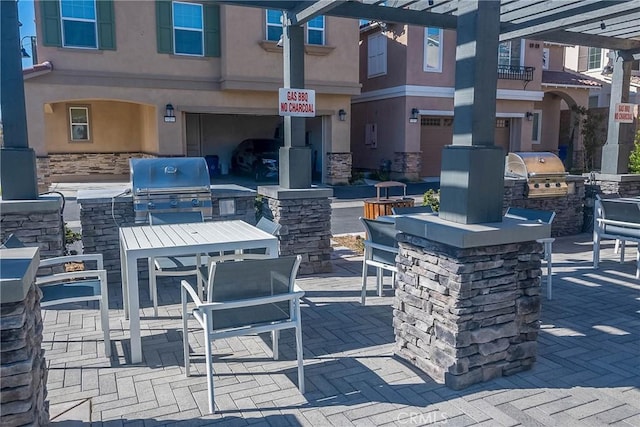 view of patio / terrace with area for grilling and a bar