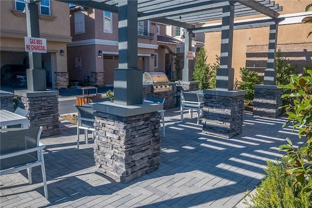 view of patio featuring area for grilling, a pergola, grilling area, and exterior bar