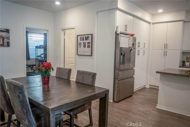 dining area featuring dark wood-type flooring