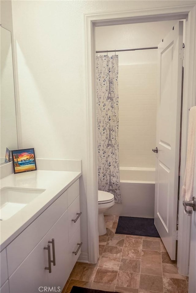 full bathroom featuring vanity, shower / bath combination with curtain, and toilet