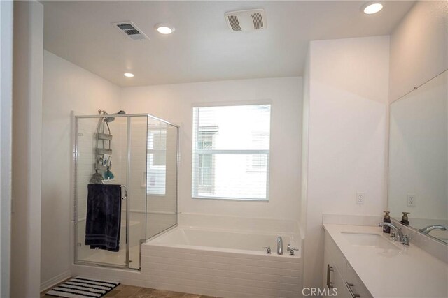 bathroom featuring vanity and plus walk in shower