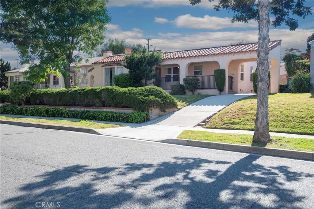 mediterranean / spanish-style house with a front lawn