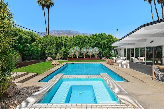 view of pool with a mountain view, a patio, and an in ground hot tub