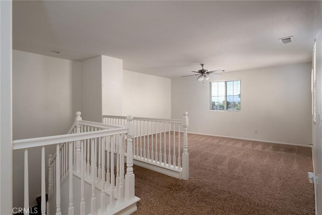 carpeted empty room featuring ceiling fan