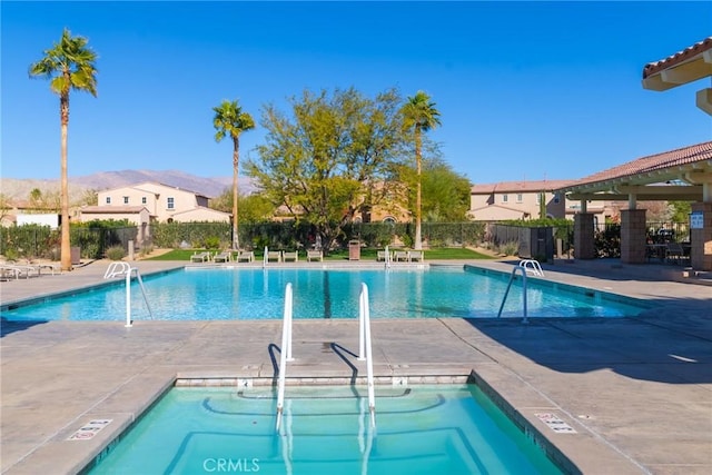 view of pool with a mountain view and a patio area