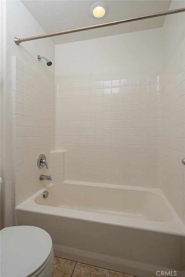 bathroom featuring tile patterned floors, toilet, and shower / bathing tub combination