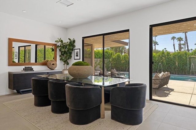 tiled dining room with a wealth of natural light