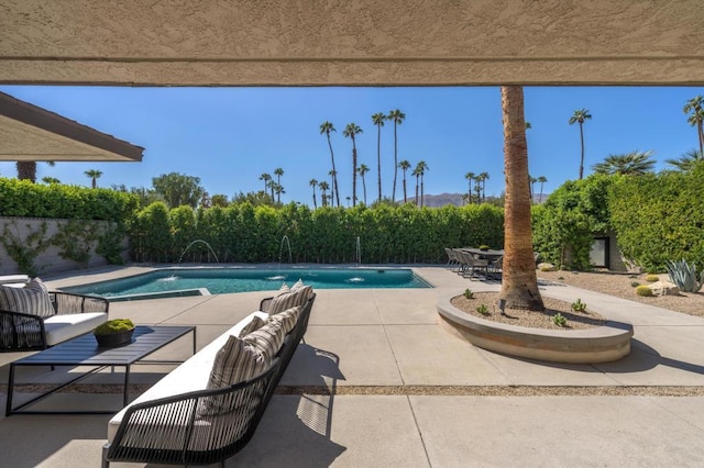 view of pool with pool water feature and a patio