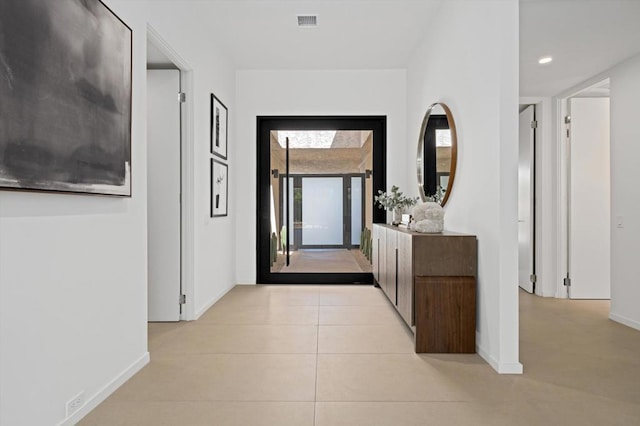 hallway featuring light tile patterned flooring